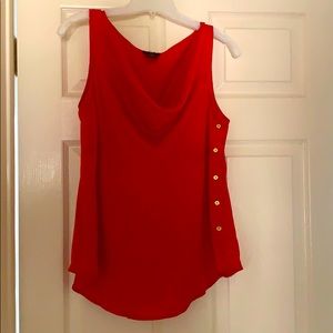 Red blouse with gold buttons and draped neck